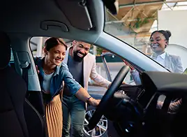 Happy Couple Looking at a Car